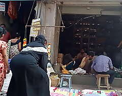 Indian muslim aunty seated bore at market