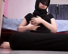A hijab wearing stepsister who is very aroused by her heavy boobs